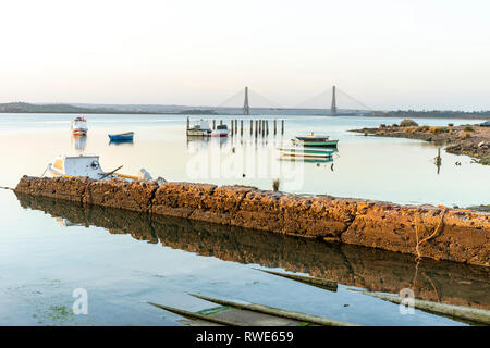 Boats and bridge over Guadiana river which is a border between Spain and Portugal, Ayamonte Stock Photo