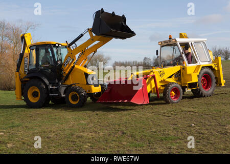 The model that made JCB great - The 3c (on the right) backhoe loader with it's modern counterpart - Still built at Rocester, Staffs UK Stock Photo