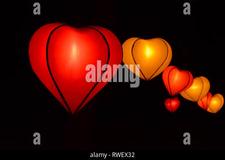 heart shape lampion lantern at park at night time isolated in black Stock Photo