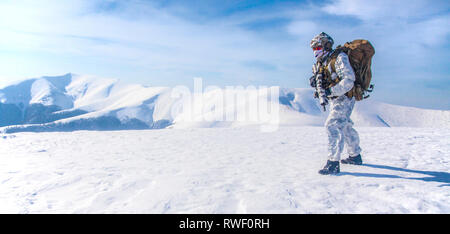 Army serviceman in winter camo somewhere in the Arctic. Stock Photo