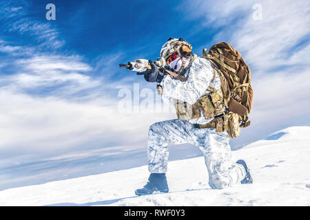 Army soldier shooting weapon in the arctic. Stock Photo