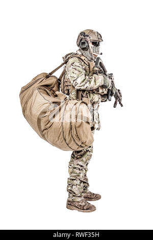 Soldier standing with duffle gym bag, studio shot. Stock Photo