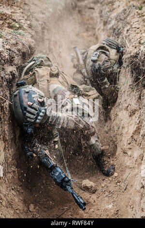 Paratroopers of French 1st Marine Infantry Parachute Regiment being attacked in trenches. Stock Photo