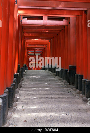 Japanese shrine entrance with red columns and black roofs background Stock Photo