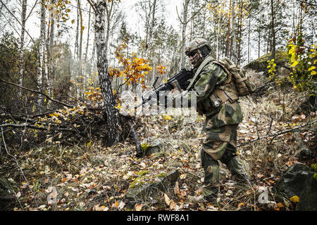 Norwegian Rapid reaction special forces FSK soldier patrolling in the forest. Stock Photo