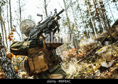 Norwegian Rapid reaction special forces FSK soldier firing in the forest. Stock Photo