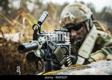 Norwegian Rapid reaction special forces FSK soldier firing in the forest. Stock Photo