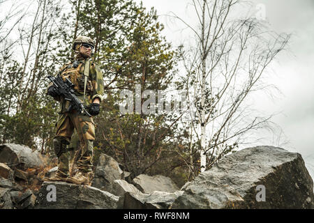 Norwegian rapid reaction special forces FSK soldier patrolling in the forest. Stock Photo