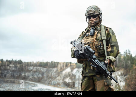 Norwegian rapid reaction special forces FSK soldier patrolling in the forest. Stock Photo