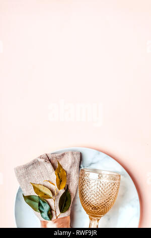 Luxurious natural table setting in golden pink tones. Minimalistic arrangement. Stock Photo