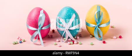 Decorated eggs stand in a row. Easter concept, banner format. Stock Photo