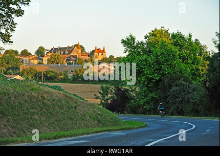 Eymet Road and village of Lauzun, Lot-et-Garonne Department, Aquitaine, France Stock Photo