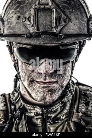 Close-up portrait of special forces soldier in combat helmet and protective glasses. Stock Photo