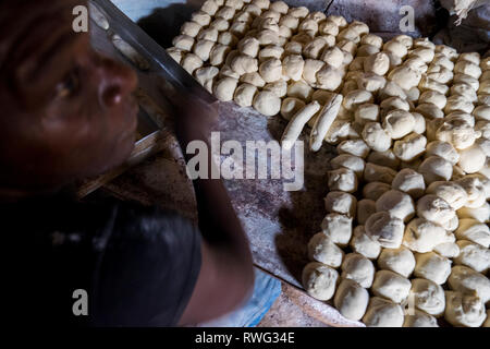 Rolling dough for bread in a bakery in Freetown, Sierra Leone. Stock Photo