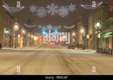 Main street in Fergus on a snowy night with Christmas lights. Fergus, Ontario, Canada Stock Photo