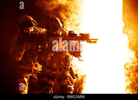 Paratroopers of French 1st Marine Infantry Parachute Regiment firing weapons. Stock Photo