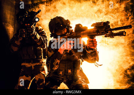 Paratroopers of French 1st Marine Infantry Parachute Regiment firing weapons. Stock Photo