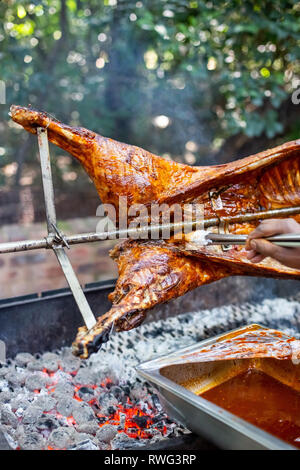 Lamb on the spit. Lamb being cooked on open fire. Stock Photo