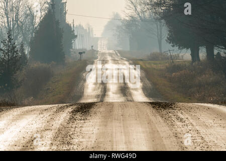 A wet rural, gravel road in early December, nr Grand Valley, Ontario, Canada Stock Photo