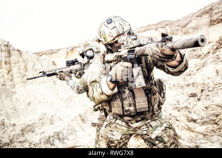 Commandos searching and attacking enemy in desert. Stock Photo