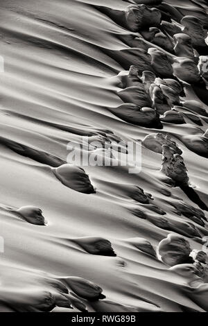 Detail of wind sculpted snow in Black and white atop Texas peak at Retallack BC, Canada Stock Photo