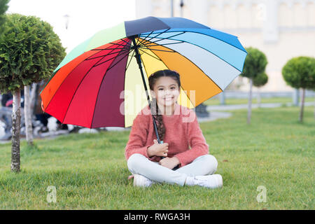Colorful accessory for cheerful mood. Girl child long hair with umbrella. Colorful accessory positive influence. Bright umbrella. Stay positive and optimistic. Everything better with my umbrella. Stock Photo