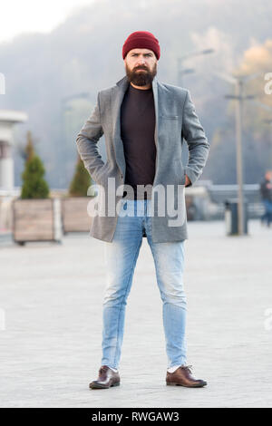 Foto de Lumbersexual style. Hipster outfit and hat accessory. Stylish  casual outfit spring season. Menswear and male fashion concept. Man bearded  hipster stylish fashionable coat and hat. Comfortable outfit do Stock