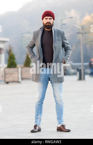 Lumbersexual style. Hipster outfit and hat accessory. Stylish casual outfit  spring season. Menswear and male fashion concept. Man bearded hipster  stylish fashionable coat and hat. Comfortable outfit Stock Photo