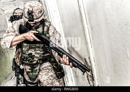 Marine assault team clearing rooms in an abandoned building. Stock Photo