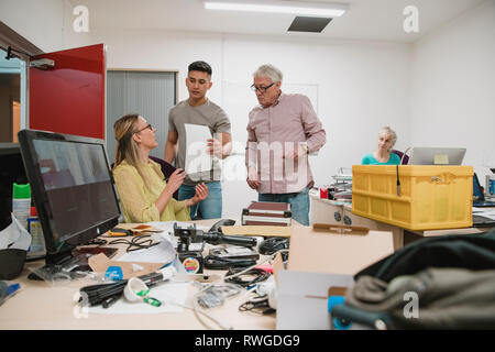 Colleagues working together in a new business office. Stock Photo
