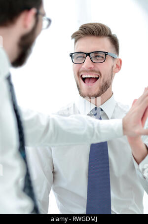 close up. smiling employees giving each other a high five Stock Photo ...