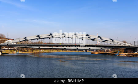 Krakow, Poland - February 16, 2019: Panoramic view of the Kotlarski Bridge over the Vistula River in Krakow. People walk and relax on the banks of the Stock Photo