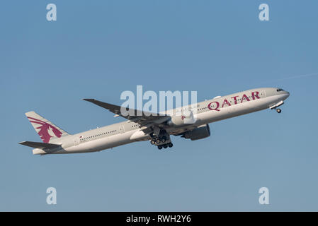 Qatar Airways Boeing 777 jet plane airliner A7-BET taking off from London Heathrow Airport, UK, in blue sky Stock Photo