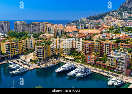 Yachts in bay near houses and hotels, Fontvielle, Monte-Carlo, Monaco, Cote d'Azur, French Riviera. Stock Photo