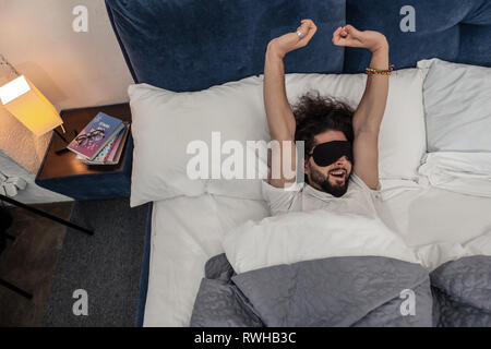 Happy nice man waking up in the morning Stock Photo