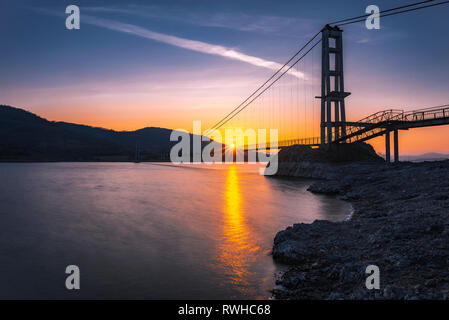 The longest suspension bridge in Bulgaria over Studen Kladenez dam with distance between the two towers of 260m. The only way to reach Lisicite villag Stock Photo