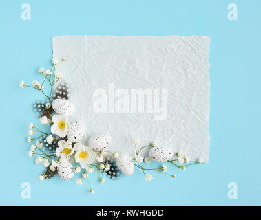 Easter card. View from above, a piece of paper with space for text on a blue background. Stock Photo