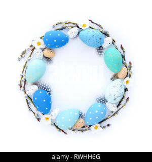 Creative Easter layout made of eggs and willow branches on white background. Circle wreath flat lay concept Stock Photo