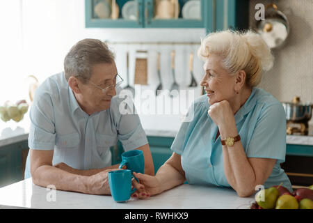 Grandparents drinking tea and talking Stock Photo