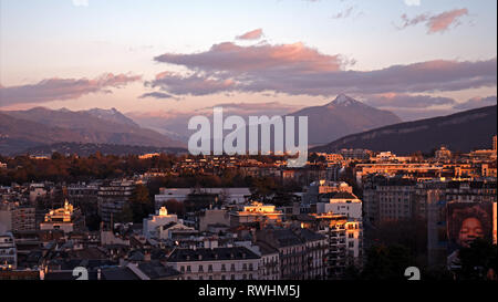 Panoramic cityscapes of Geneva in Switzerland.  Tthe rooftops of Geneva and the surrounding mountains at sunset as the sunlight reflect Stock Photo