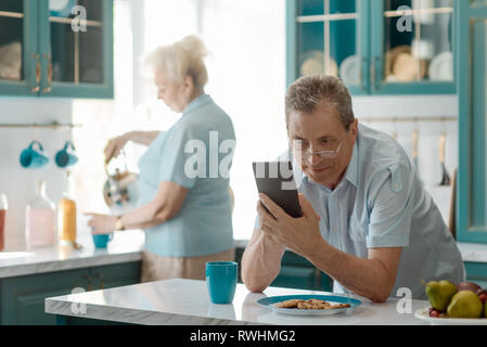 Grandad using a smart phone Stock Photo