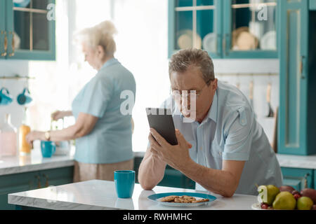 Surprised man reading bad news Stock Photo