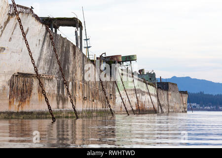 Concrete barges, used as a floating breakwater for Catalyst Paper's Mill in Powell River, British Columbia, Canada Stock Photo