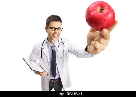 Smiling young male doctor holding a red apple in front of the camera isolated on white background Stock Photo