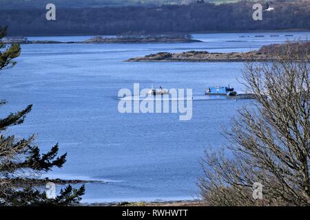 Two Scottish Sea Farms boats serving salmon cages at South Shian . Stock Photo
