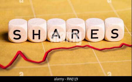 Rising red curve with letter cubes showing the word shares. Stock Photo