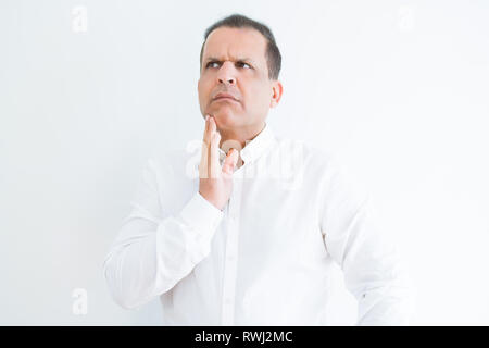 Middle age man thinking clueless about a question Stock Photo