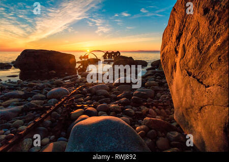 Sunsetting over the gulf of St. Lawerence at the site of the century old ship wreck of th s.s. Ethie, Gros Morne National Park, Newfoundland and Labrador Stock Photo