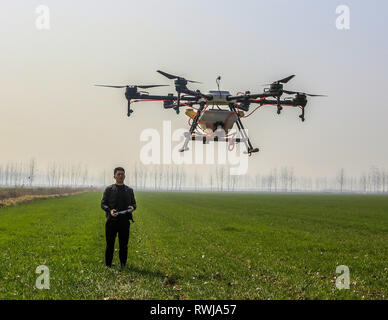 Suqian, China's Jiangsu Province. 6th Mar, 2019. A farmer operates an agricultural drone to spray pesticides in Jinsuo Township, Sihong County of Suqian, east China's Jiangsu Province, March 6, 2019. This Wednesday marks the day of 'Jingzhe', literally meaning the waking of insects, which is the third one of the 24 solar terms on Chinese Lunar Calendar. With the temperature rising, farmers are busy with their farm work. Credit: Zhang Lianhua/Xinhua/Alamy Live News Stock Photo
