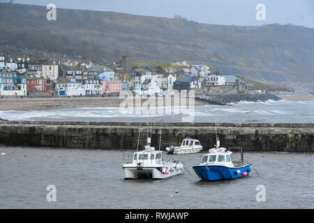 Lyme Regis, Dorset, UK. 6th Mar, 2019. UK Weather. View from the Cobb Harbour back towards the town of Lyme Regis in Dorset on a day of overcast skies and a stiff breeze. Picture Credit: Graham Hunt/Alamy Live News Stock Photo